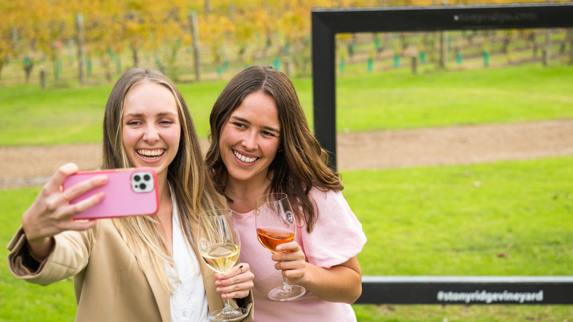 A couple taking a selfie in a vineyard during a date
