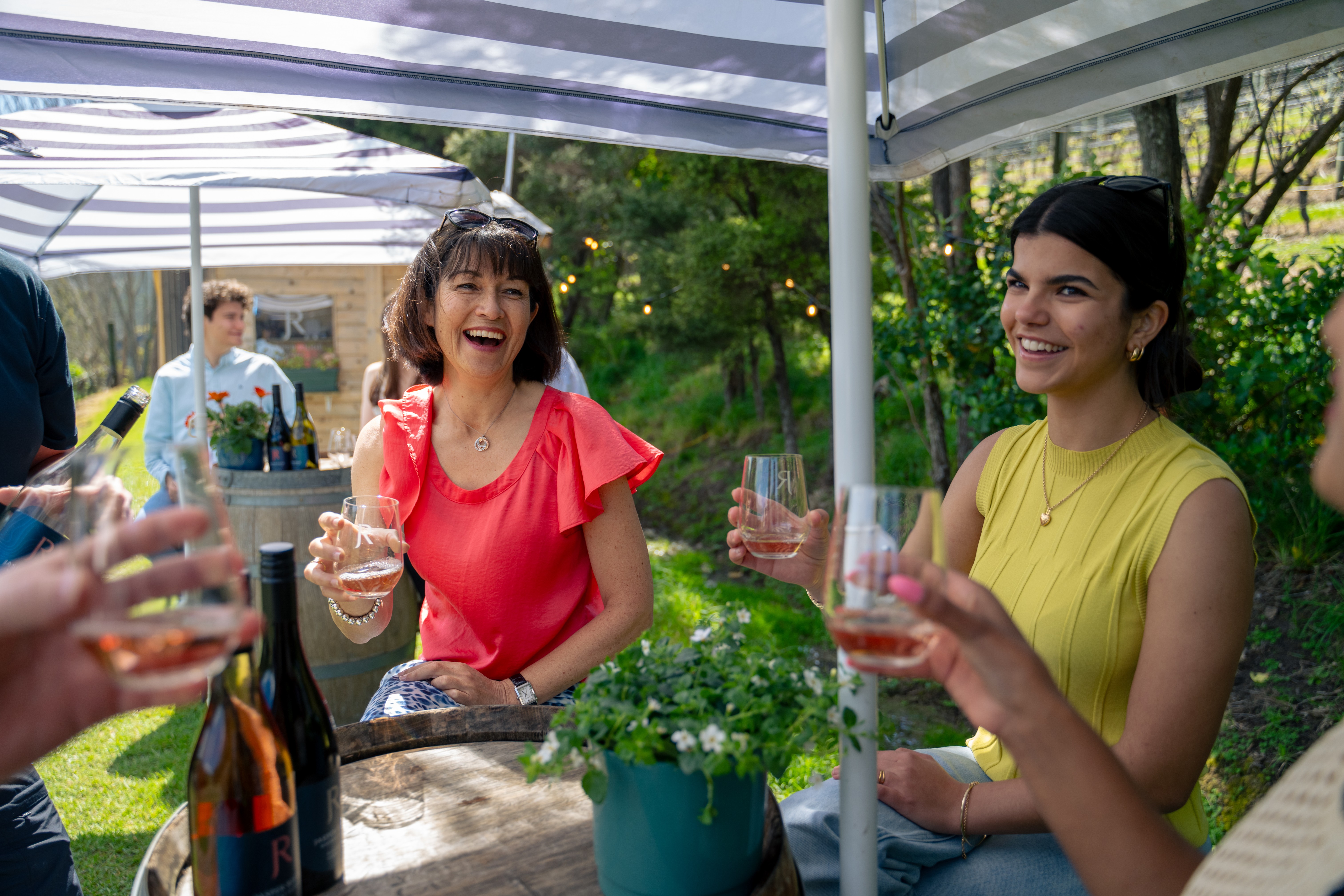 Friends enjoying wine tasting at a Waiheke Island vineyard, perfect Mother’s Day experience