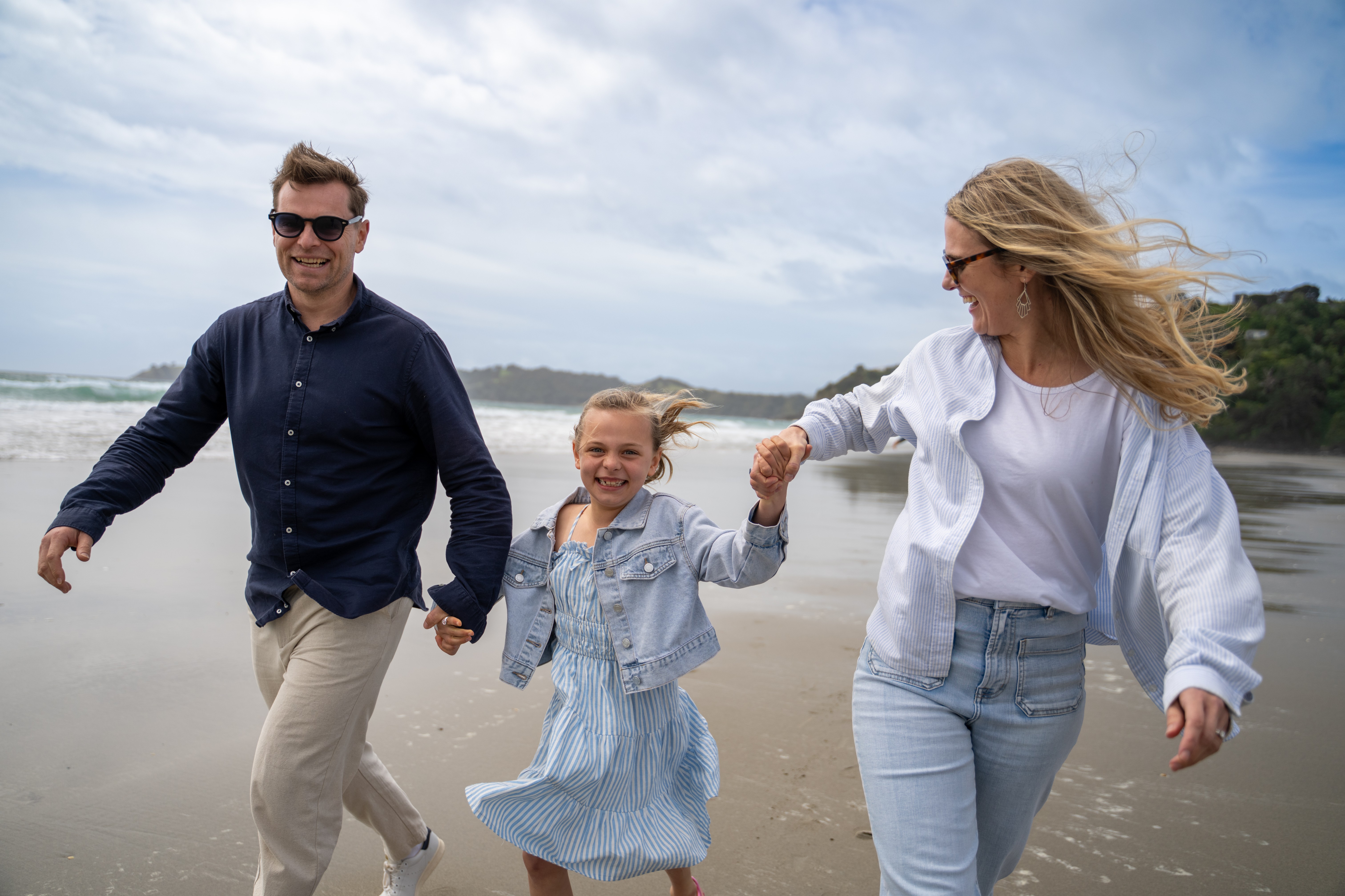 Family walking along the beach on Waiheke Island, enjoying a relaxed Mother’s Day outing together